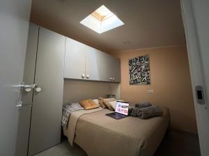 a bedroom with a bed with a laptop on it at Bilocale in pieno centro a Campobasso in Campobasso