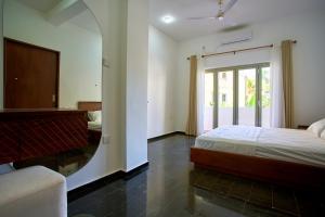 En eller flere senge i et værelse på The Retreat Minimum 3 Nights