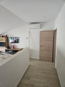 a room with a hallway with a door and a room at Apartment Anton in Selce