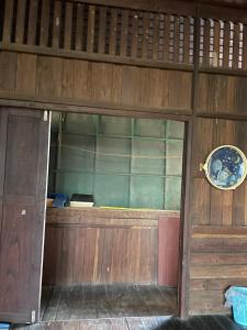 a wooden door with a plate on top of it at YPHomestay in Pai