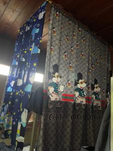 a bedroom with a curtain with mickey mouse on it at YPHomestay in Pai +99 photos