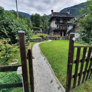 a wooden gate in front of a house at La Baita di Guenda in Varzo