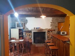 a dining room with a fireplace and a table and chairs at La Baita di Guenda in Varzo +47 photos