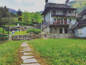 a stone path in front of a house at La Baita di Guenda in Varzo