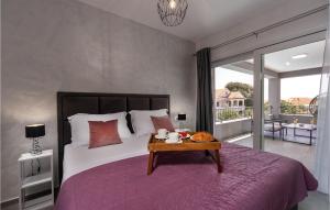 a bedroom with a large bed with a table on it at Villa Bibinje in Bibinje