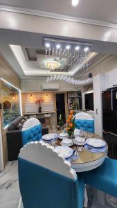 a dining room with a table and blue chairs at SMDC Coast Residences in Manila