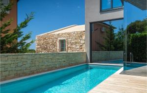 a swimming pool in front of a house at Villa Hello Sunshine in Poreč