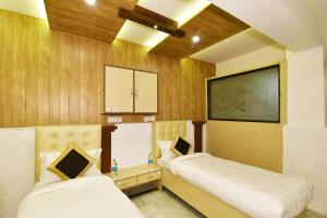two beds in a room with wooden walls at Hotel sallow International-Hotel Near Golden Temple in Amritsar