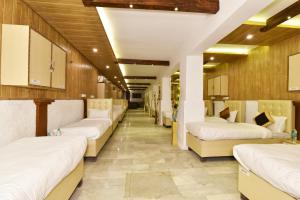 a row of beds in a room at Hotel sallow International-Hotel Near Golden Temple in Amritsar