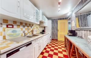 a kitchen with white cabinets and a checkered floor at Lovely Home In Saint-Maurice-Sur-Eygu in Saint-Maurice-sur-Eygues +32 photos