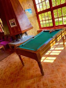 a pool table in the middle of a room at Ferme D’hôte La Vallée in Azrou