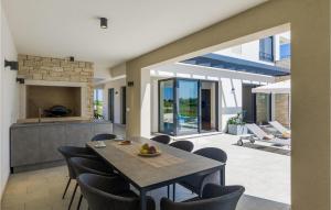 a kitchen and dining room with a table and chairs at Villa Luna in Brtonigla