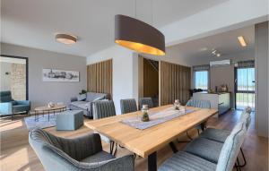 a living room with a wooden table and chairs at Villa Luna in Brtonigla