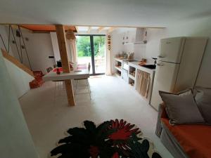 eine Küche und ein Wohnzimmer mit einem Kühlschrank mit Gefrierfach in der Unterkunft La casita, maison individuelle avec jacuzzi in Falck + 6 Fotos