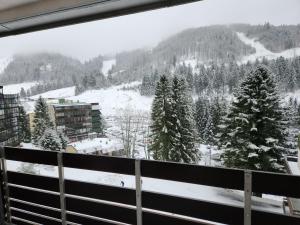 a view of a snow covered mountain from a balcony at Studio pistes La Bresse Hohneck in La Bresse