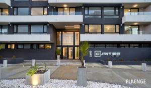 a building with a palm tree in front of it at Departamento amoblado, centrico in Temuco +6 photos