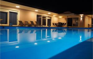 a swimming pool at night with blue lights in it at Villa Heaven in Heki +49 photos