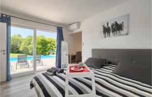 a bedroom with a bed and a table and a pool at Villa Heaven in Heki