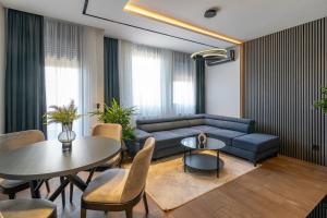 a living room with a blue couch and a table at The Residence 59 in Belgrade +84 photos