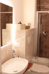 a bathroom with a sink and a toilet and a shower at Luna Nuova Gallipoli Comfort & Suites in Gallipoli