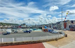 a marina with cars parked in a parking lot at 2 Bedroom Stunning Home In Fécamp in Fécamp +14 photos