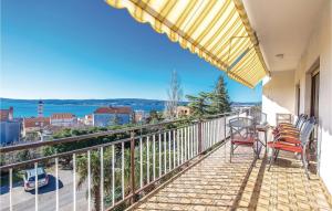 a balcony with chairs and a table with a view at Cozy Apartment In Crikvenica in Crikvenica