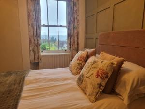 Ένα ή περισσότερα κρεβάτια σε δωμάτιο στο Montfort Cottage Guest House