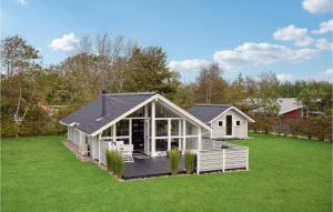 a house with a conservatory on a lawn at Amazing Home In Tarm With Wifi in Tarm +31 photos