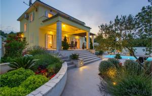 a house with a swimming pool in front of it at Villa Tatijana in Zadar