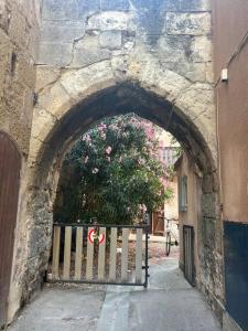 an archway in a stone building with a gate at Appart Distillerie in Narbonne