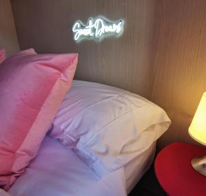 a bed with a pillow and a sign that reads just baby at Sweet Dream in Passignano sul Trasimeno
