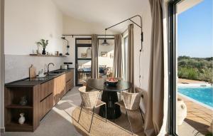 a kitchen and dining room with a table and a pool at Villa Eco in Orbani