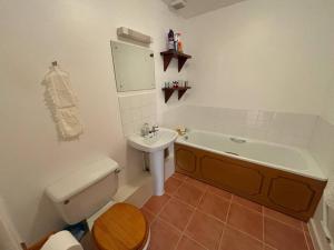 a bathroom with a sink and a tub and a toilet at West Down in Glastonbury