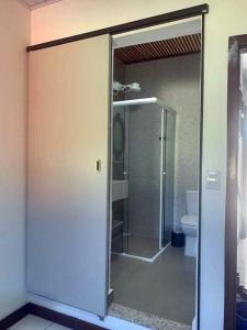 a bathroom with a glass shower and a toilet at Cana Caiana Casa in Paraty +11 photos