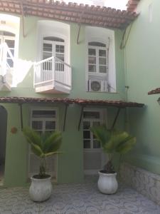 two palm trees in front of a house at Santo Antônio Bahia 7 in Salvador