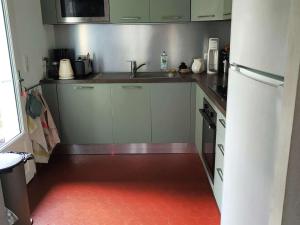 a small kitchen with a sink and a refrigerator at Villa spacieuse avec jardin pour 16 personnes - FR-1-736-31 in Lège-Cap-Ferret