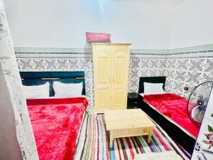 Postel nebo postele na pokoji v ubytování Riad Dar Lokman