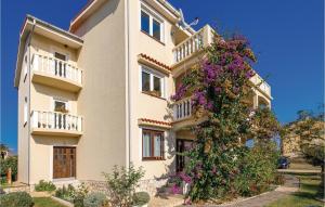 a building with flowers on the side of it at Beautiful Apartment In Povljana in Povljana +25 photos