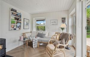 a living room with a couch and chairs and a table at 2 Bedroom Awesome Home In Kerteminde in Kerteminde