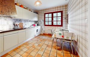 a kitchen with a sink and a table in it at Cozy Home In Saint-Georges-De-Didonne in Saint-Georges-de-Didonne