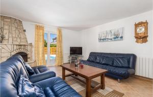 salon z niebieskimi skórzanymi kanapami i stołem w obiekcie 6 Bedroom Beautiful Home In Povljana w mieście Povljana