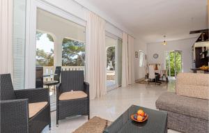 a living room with a couch and a table at Six-Bedroom Holiday Home In Sibenik in Šibenik