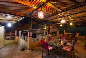 a dining room with a table and chairs and lights at Casa Aya Medina in F&egrave;s