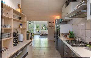 a kitchen with a stove and a counter top at Holiday Home Mimice 21 With Outdoor Swimmingpool in Mimice