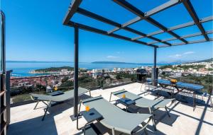 a balcony with tables and chairs and a view of the ocean at Villa Rhapsody 2 Aurelia 2 in Makarska +38 photos