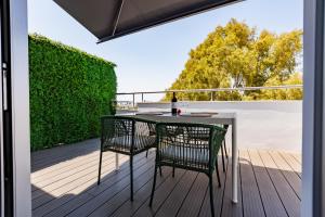 a patio with a table and chairs on a deck at The Palm Suites - Adults Only in Limassol