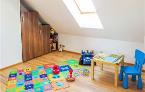 a childs room with a table and a toy crib at 3 Bedroom Beautiful Home In Mscicie in Podamirowo