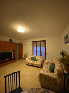 a living room with two couches and a television at Sa Perda Bianca 8 in Cagliari