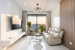 a living room with a couch and a table at Oh, My Dear! Apartment - RiverGate in Ho Chi Minh City