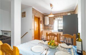 a dining room table with wine glasses on it at 4 Bedroom Cozy Home In Facinas in Facinas